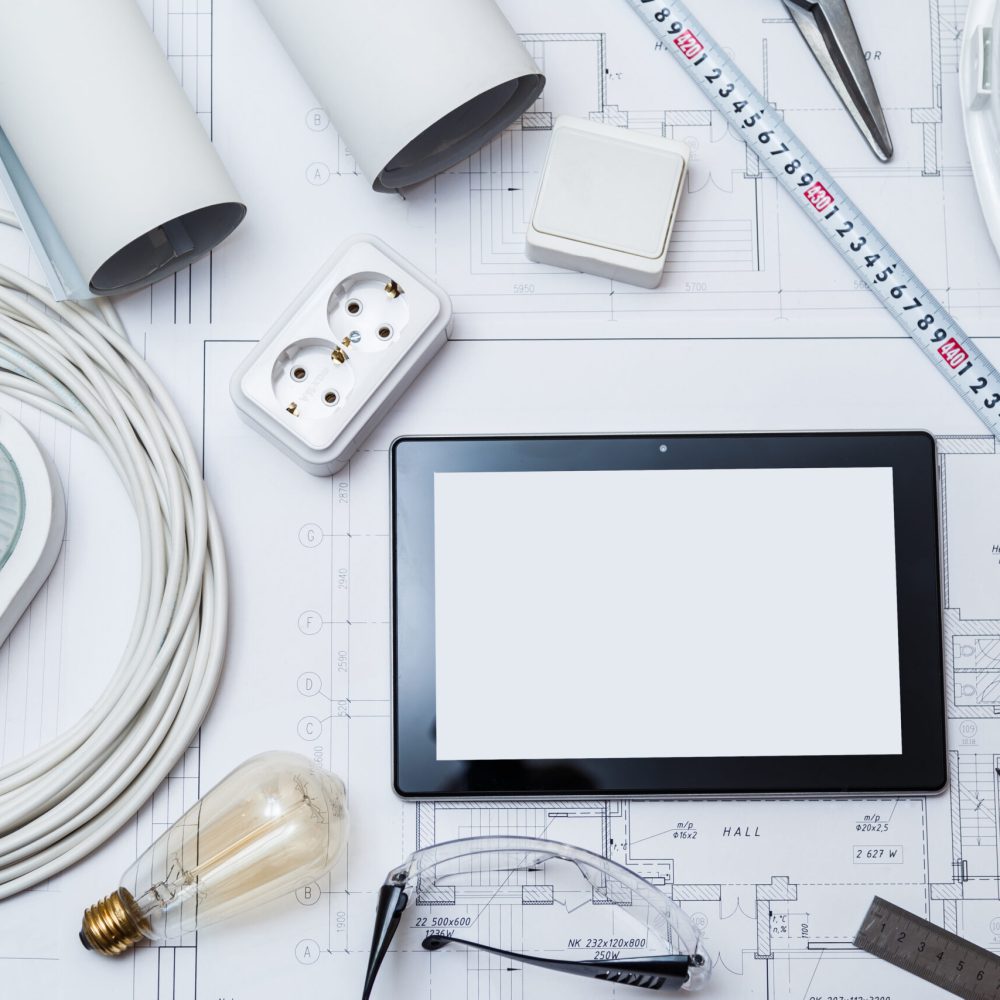 Construction drawing with tools and tablet with blank screen. top view